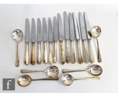 A set of six modern silver handled dessert and dinner knives with a six further rat tail pattern soup spoons, weight of spoon