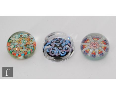 A later 20th Century Strathearn glass paperweight with central ring of millefiori canes, surrounded by white latticino canes 