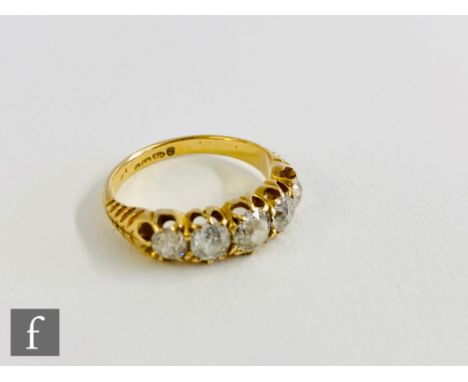 An 18ct hallmarked five stone diamond ring, old cut claw set stones, largest approximately .40ct, to chevron detailed shoulde