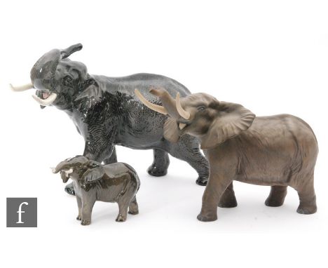 Three Beswick model elephants comprising a 'Trunk stretching' model 998 in satin matt, a 'Trunk in Salute' model 1770 and a '