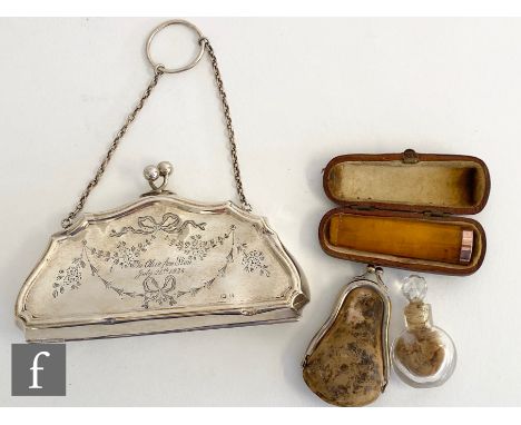 A hallmarked silver lady's evening purse with part engraved swag decoration with a gold mounted amber cigar holder and a smal