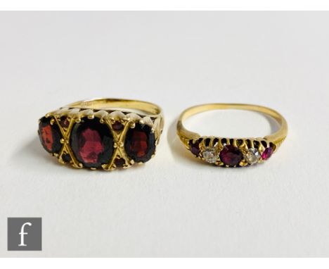 An early 20th Century 18ct ruby and diamond five stone boat shaped ring with a later 9ct garnet seven stone example, (2) 