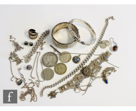 A small parcel lot of assorted silver jewellery to include bangles, chains, earrings coins etc, total weight 241g. 