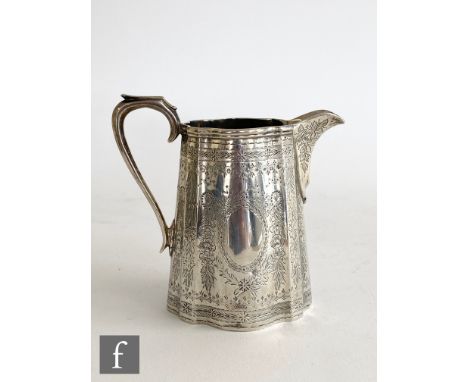 A Victorian hallmarked silver cream jug of slender form with aesthetic foliate engraved decoration, London 1875, Barnard Bros