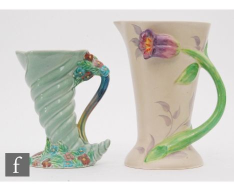 A Clarice Cliff Wilkinson Pottery jug decorated with a relief applied tulip, the stem running down the body to form the handl