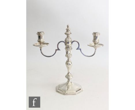 A hallmarked silver twin light candelabra, stepped hexagonal base below knop column, scroll arms and hexagonal sconces, heigh