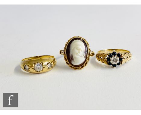 A 9ct gypsy set paste three stone ring with a 9ct cameo ring and a sapphire and diamond example, total weight 10.5g, various 