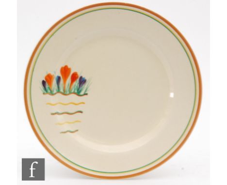 A Clarice Cliff 10in plate decorated in the Riverside Crocus pattern with a spray of flowers above wavy lines, printed script