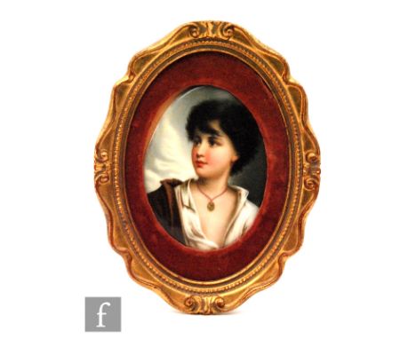 A small early 20th Century oval porcelain plaque hand painted with a portrait of a young shepherd boy, after the original by 