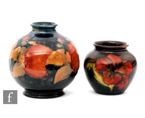 Two Moorcroft vases, the first of ovoid form decorated in the Pomegranate pattern with a band of whole fruit and berries, imp