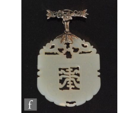 A Chinese jade carved pendant, Qing Dynasty (1664-1911), the pale green stone, with slight russet inclusions, of rounded arch