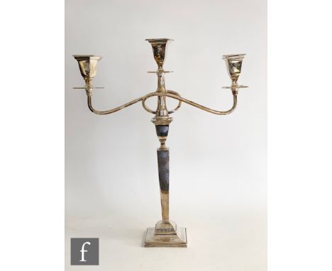 A hallmarked silver three light candelabra, square base below plain flaring column, scroll arms and square sconces, height 42