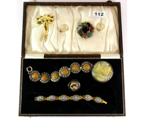 A case of mixed jewellery including two gold rings and a sterling silver mounted carved jade disc.