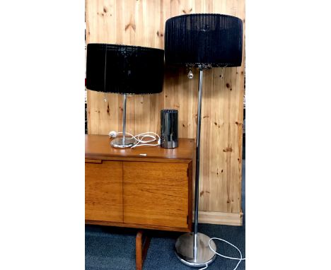 A chrome and black shade standard lamp and matching table lamp together with a mirrored vase.