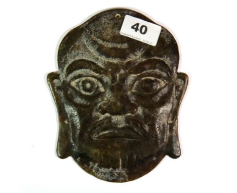 An unusual Chinese carved mixed colour jade panel depicting a man's head, pierced to be mounted on the wall or hang as a tass
