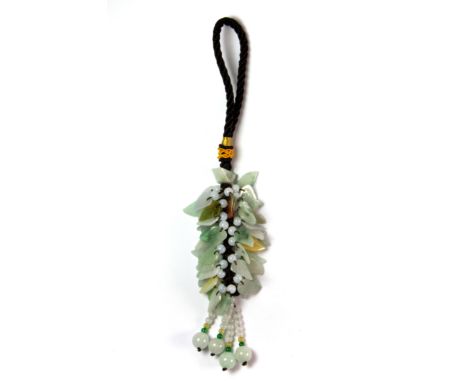 A silk mounted tassle of carved jade leaves and beads, L. 21cm.