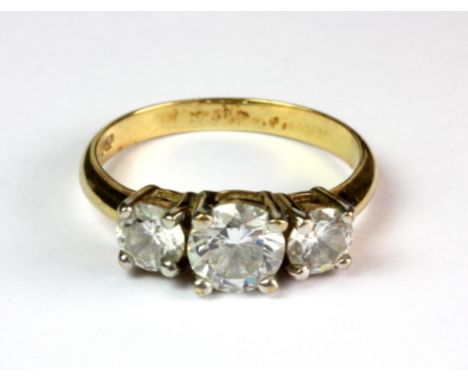 An 14ct yellow gold (stamped 14k) ring set with three brilliant cut white stones (R).