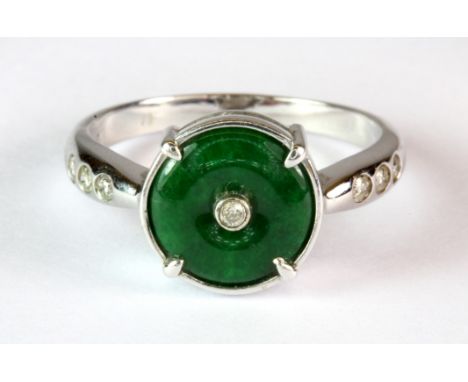 An 18ct white gold (stamped 19k) ring set with a jade Huaigu and diamond set shoulders (O).