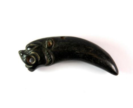 An interesting Japanese carved stone netsuke tiger's tooth and tiger's head, L. 9cm.