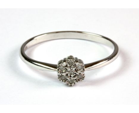A 9ct white gold (stamped 375) diamond set cluster ring (R.5).