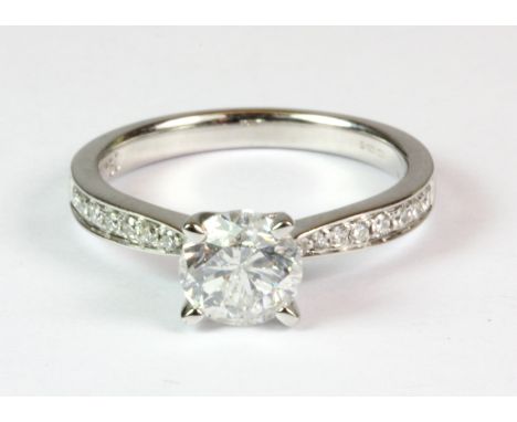 An 18ct white gold brilliant cut diamond solitaire ring (approx. 1.16ct) with diamond set shoulders together with E. D. R. ri