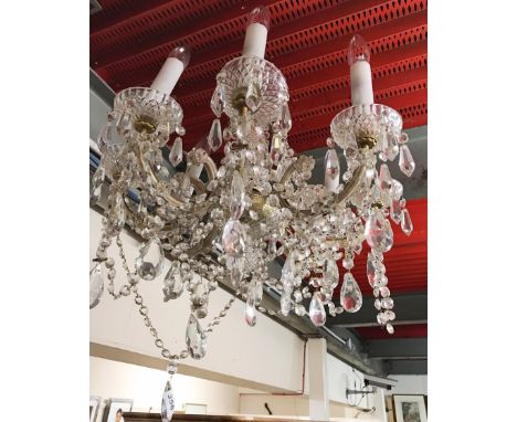 A glass eight branch chandelier light fitting.