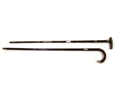 A 19th century white metal mounted sword stick together with a silver mounted walking stick.