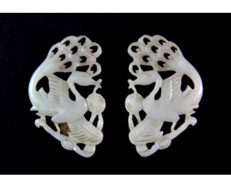 A pair of early 20th century Chinese nephrite jade figures of peackocks, probably used as part of a hair or crown decoration,