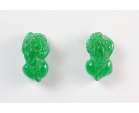 A pair of 18ct white gold plated metal mounted carved jade stud earrings in the shape of Chinese lion dogs, L. 1.7cm.