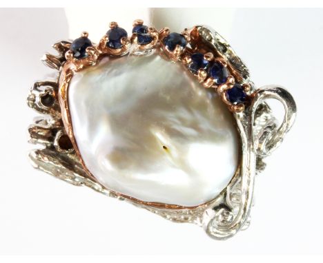 A Hana Maae silver gilt ring set with a large baroque pearl and sapphires (R).