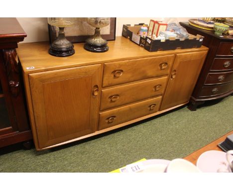 Ercol Blonde Elm Sideboard of 3 drawers flanked by Cupboards. mounted on casters 