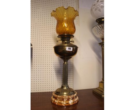 Edwardian Brass Reservoir Oil Lamp with Amber glass shade terminating on ceramic base 