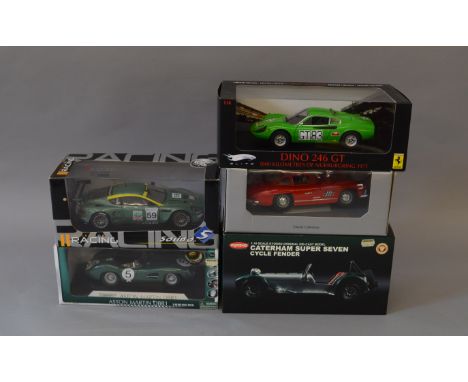 Five 1:18 scale diecast models: Kyosho Caterham Super Seven Cycle Fender; Hot Wheels Elite Dino 246 GT; Shelby Aston Martin 5