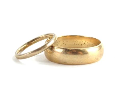 Two 9ct gold wedding bands, each of plain design, ring sizes Y and K, 8.7g all in, the larger ring bearing a partial engravin