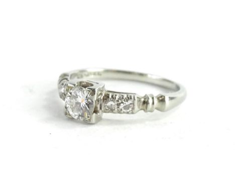 A small diamond ring, set in white coloured metal, stamped 18k.