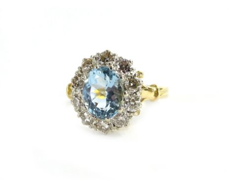 An Aquamarine and diamond cluster ring, set in 18ct gold, size O.