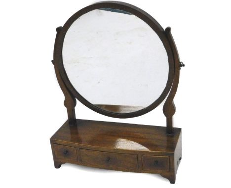 A mahogany dressing table mirror, in George III style, the circular bevelled plate on shaped supports, the bow fronted base w