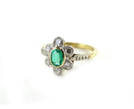 An emerald and diamond daisy shaped ring, set in 18ct gold, ring size R.