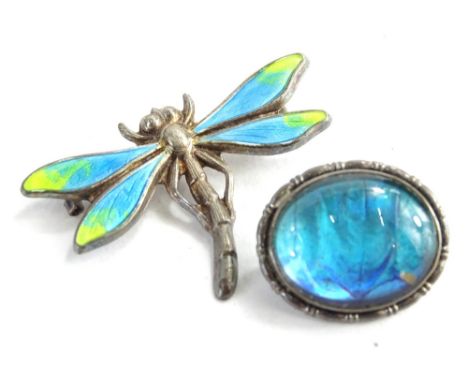 Two modern silver brooches, to include a silver and enamel dragonfly brooch, the wings with blue and green enamel design, lac