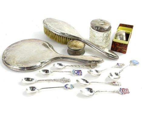 A collection of small silver, to include commemorative spoons, a d shaped napkin ring, silver mounted mirror, and matching ha