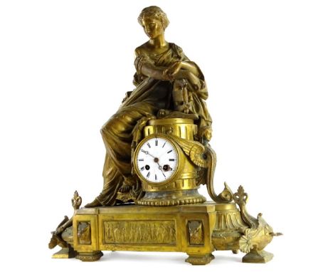 A 19thC French gilt metal figural mantel clock, modelled in the form of a lady seated on a pedestal, the white enamel dial wi