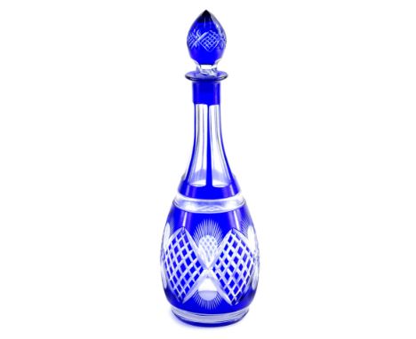 An early 20thC Bohemian blue and clear glass decanter, with shaped stopper and diamond cut body, with a repeat floral pattern