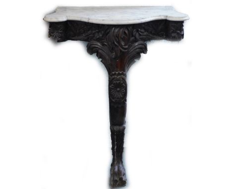 A 19thC carved oak monopodia console table, with a white marble shaped top, leaf and flower head carved frieze on single leg 