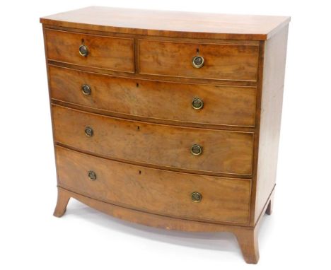 An early 19thC mahogany bow fronted chest of drawers, with a plain top, above two short and three long , each with brass hand
