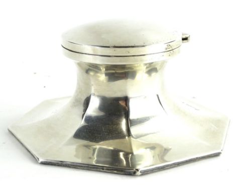 A George V silver Capstan inkwell, the hinged lid enclosing a glass liner on an octagonal base, loaded, Birmingham 1919, 14cm