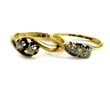 Two 18ct gold and platinum diamond set twist rings, one of two stone design, ring size M½, the other with three illusion set 