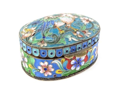 A Russian white metal and cloisonne enamel oval box, the hinged lid decorated with a bird, flanked by flowers, leaves, etc., 