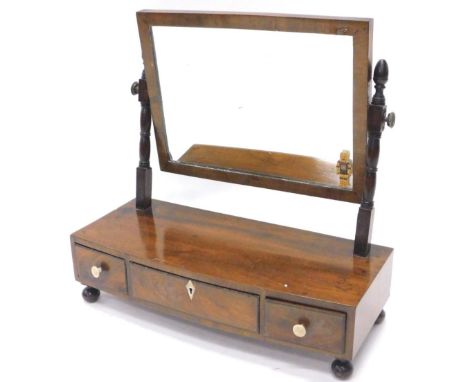 A 19thC mahogany dressing table mirror, the rectangular plate on turned supports, the bow fronted base with three drawers on 