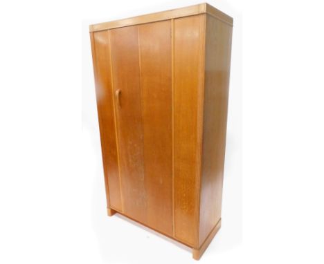 A retro light oak wardrobe, with single door, on block feet, 107cm W.