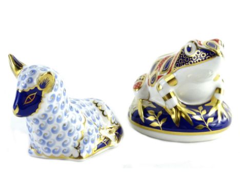 A Royal Crown Derby ceramic model of a recumbent lamb, with gold button and a similar frog, both boxed.